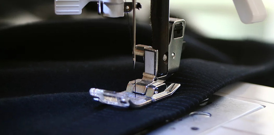 Industrial sewing machine stitching heavy-duty fabric for custom boat covers and upholstery services